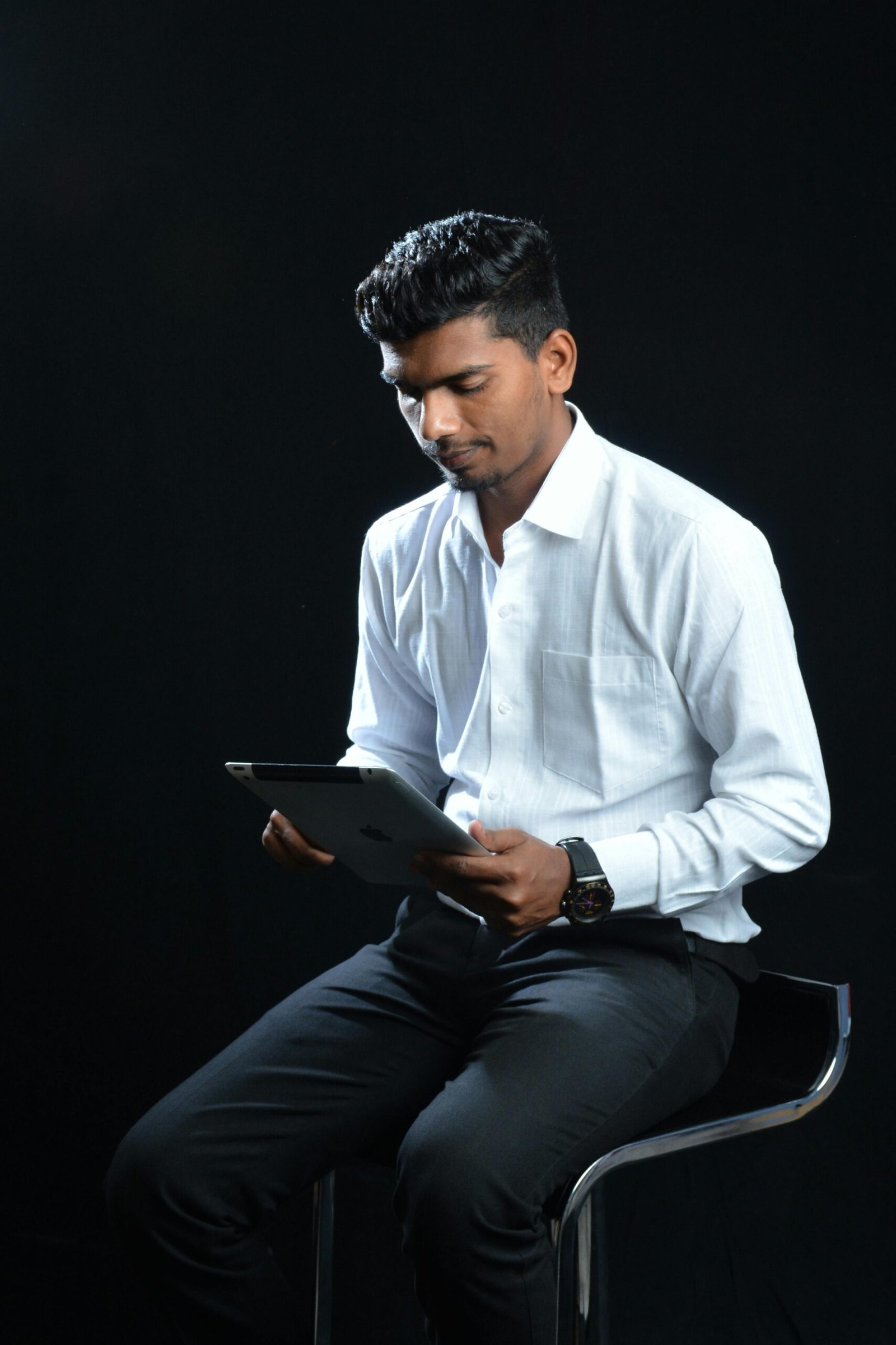 Portrait of a man using a tablet in a professional setting.